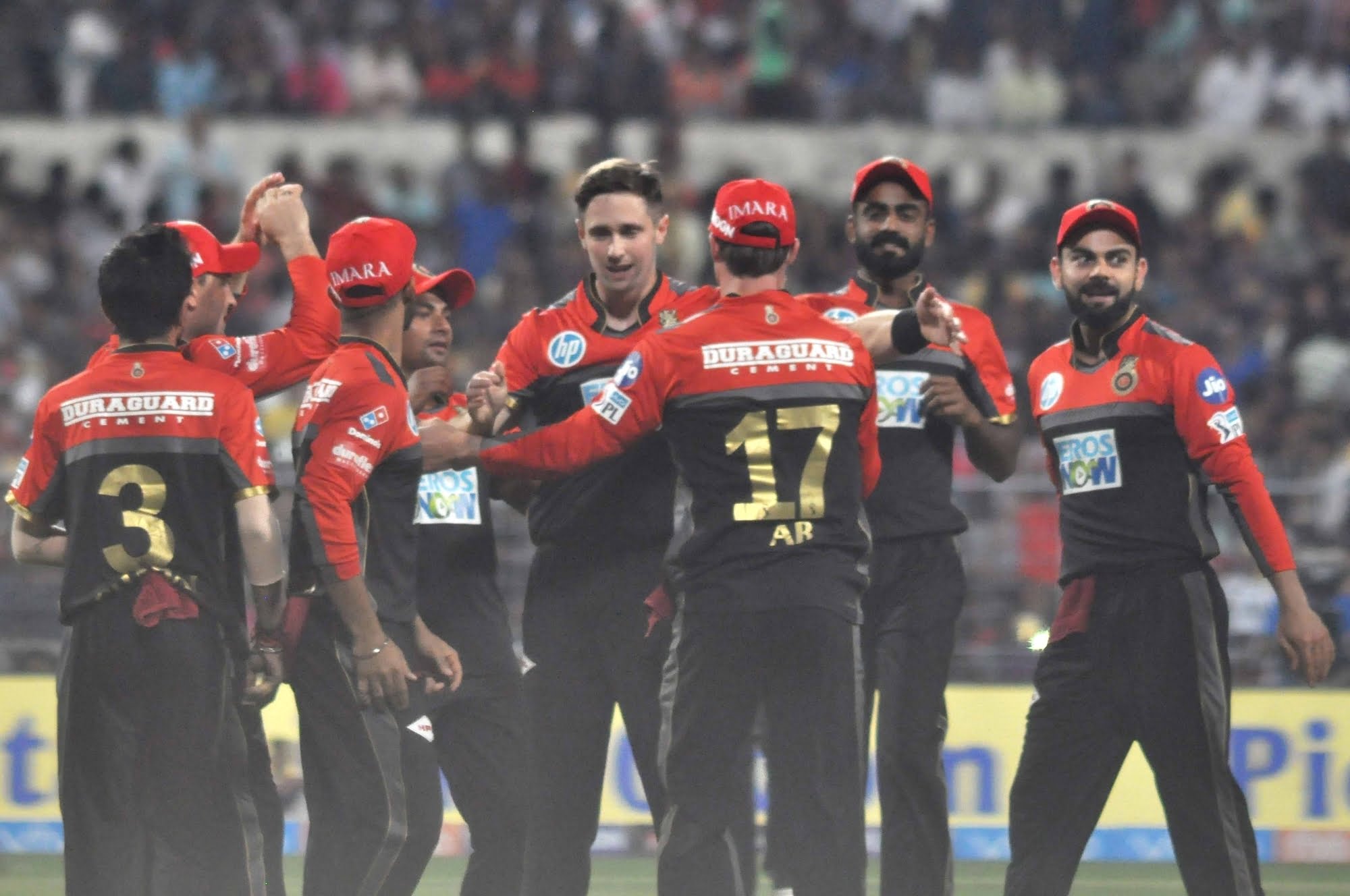 Kolkata: Royal Challengers Bangalore players celebrate fall of a wicket during an IPL 2018 match between Kolkata Knight Riders and Royal Challengers Bangalore at the Eden Gardens in Kolkata 